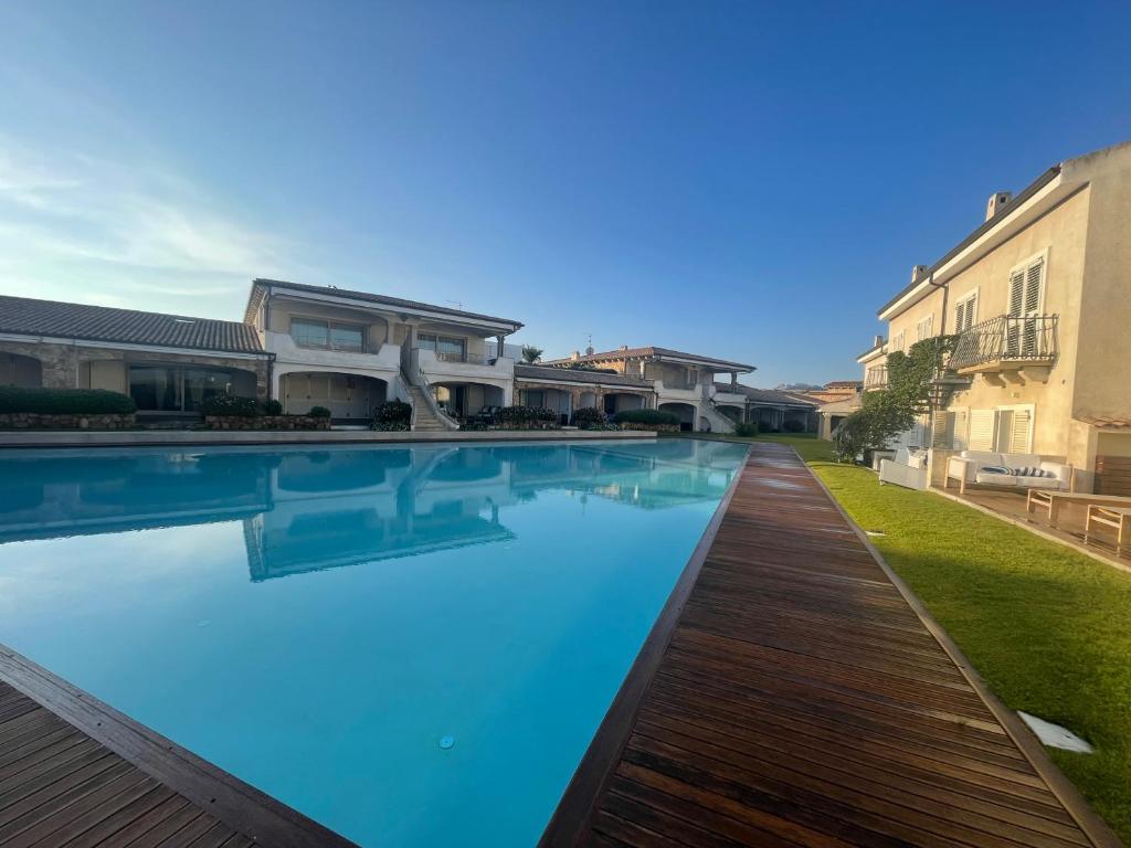 a swimming pool in front of a house at Gardenia Luxury in Palau