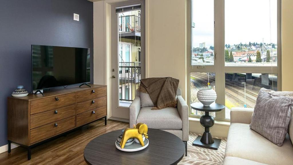 a living room with a couch and a tv at Landing Modern Apartment with Amazing Amenities (ID8493X21) in Tacoma