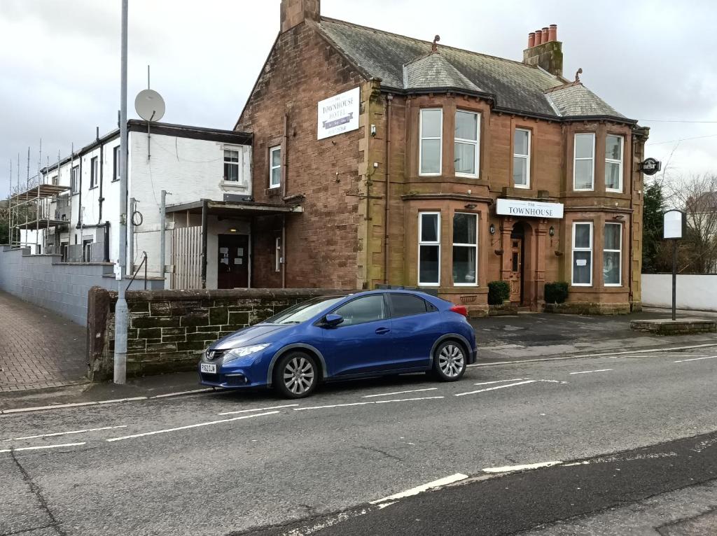 a blue car parked on the side of a street at The Townhouse Self Catering in Dumfries