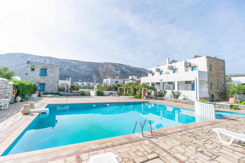 a large swimming pool in front of a house at NORMA'S VILLAGE in Kalymnos