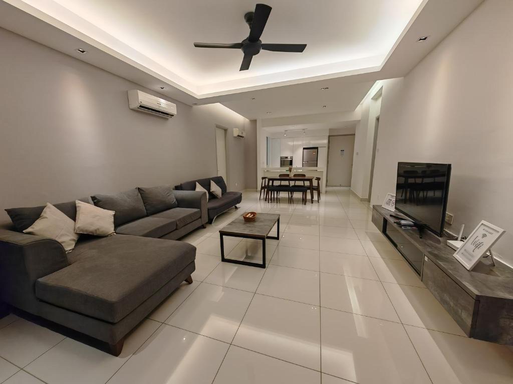 a living room with a couch and a ceiling fan at Harmony Haven with Bathtub - Jazz Suites by Ocean Luxe in Tanjong Tokong