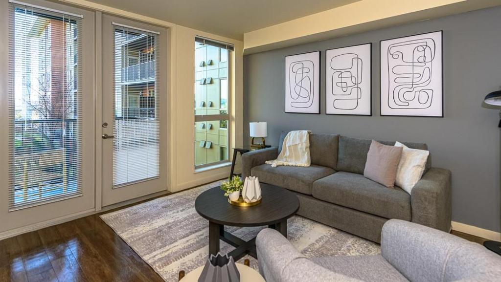 a living room with a couch and a table at Landing Modern Apartment with Amazing Amenities (ID8426X91) in Tacoma