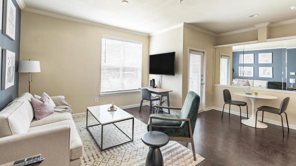 a living room with a couch and a table at Landing Modern Apartment with Amazing Amenities (ID6588X72) in Richardson