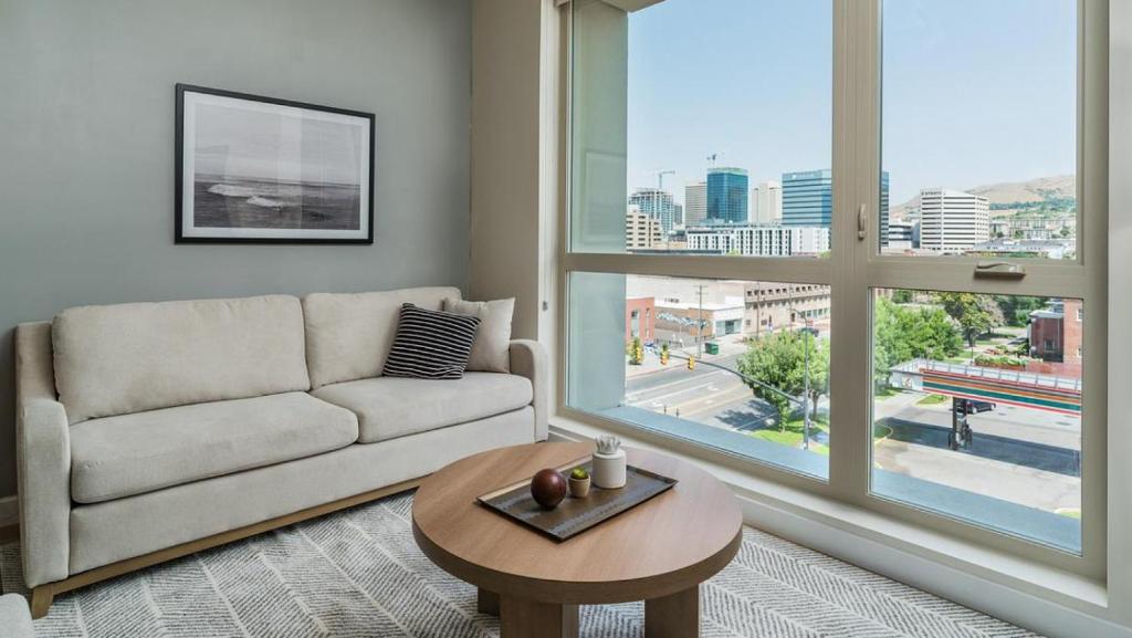 a living room with a couch and a table at Landing Modern Apartment with Amazing Amenities (ID6454X40) in Salt Lake City