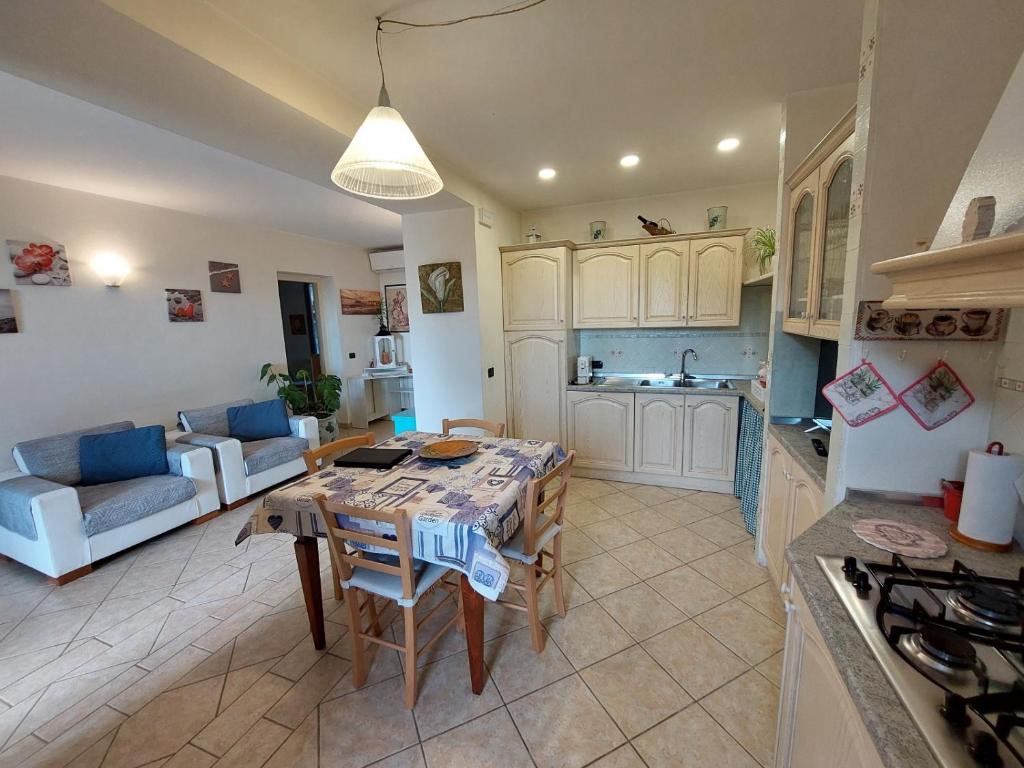 a kitchen and living room with a table and a couch at Casa Bianca in Pietrasanta