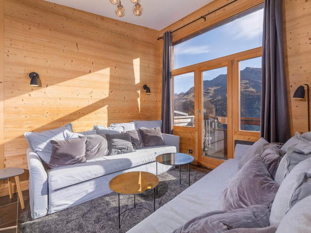 a living room with a couch and a large window at Appartement Prestige 3 Pièces à Avoriaz - 5/7 Pers, Ski In/Out, Balcon Plein Sud, Équipements Haut de Gamme - FR-1-314-234 in Morzine