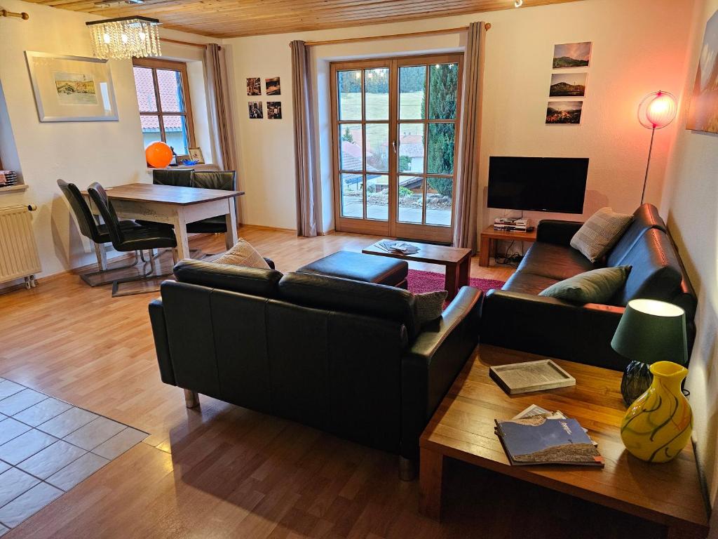 a living room with a couch and a table at Jungholz Erlebnis in Jungholz