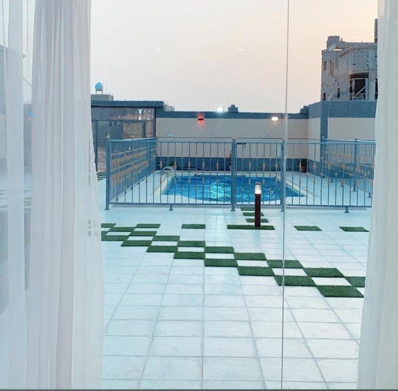 a view of a swimming pool from a window at Silver stones شاليه سيلفر ستونز in Al Madinah