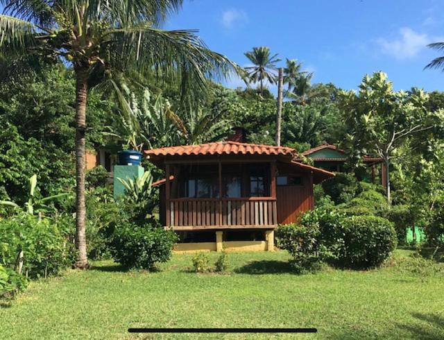una pequeña casa con un porche en un patio en Casa do João en Ilha de Boipeba