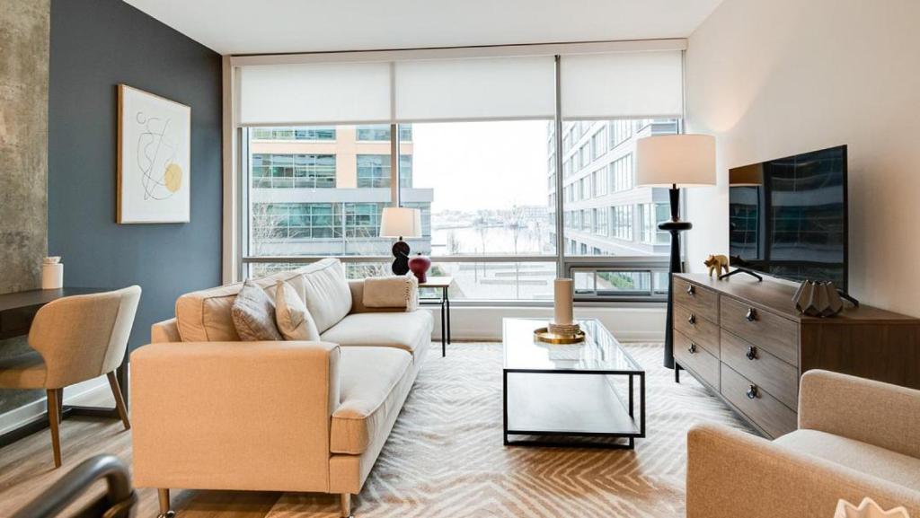 a living room with a couch and a tv at Landing Modern Apartment with Amazing Amenities (ID7709X66) in Baltimore