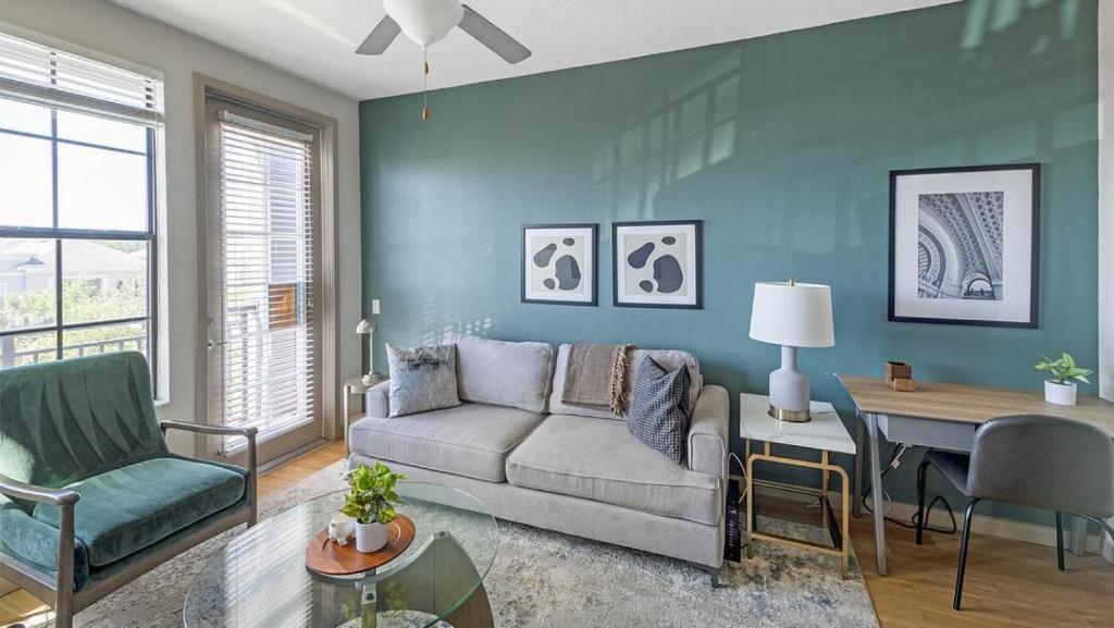 uma sala de estar com um sofá e uma mesa em Landing Modern Apartment with Amazing Amenities (ID4310X3) em Orlando