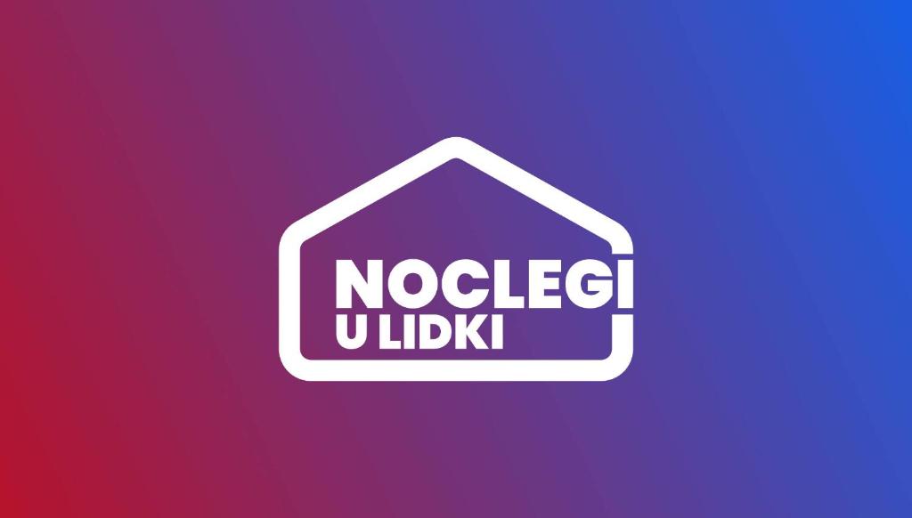 a sign with the words noelicit udlisk on a purple background at Noclegi u Lidki 