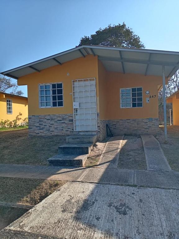 ein kleines gelbes Haus mit weißer Tür in der Unterkunft Casa Mendoza 