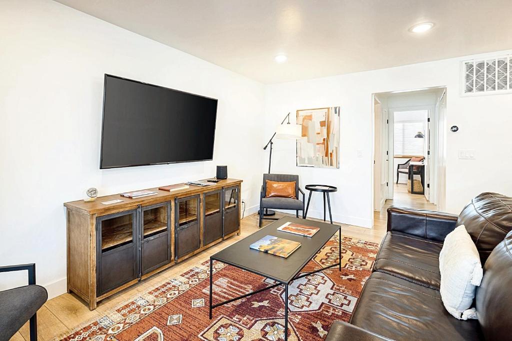 a living room with a couch and a flat screen tv at Near Downtown Stylish 2BR With Amazing Patio - 5 in Moab