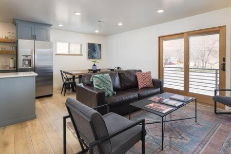 a living room with a couch and a table at Near Downtown Stylish 2BR With Amazing Patio - 6 in Moab