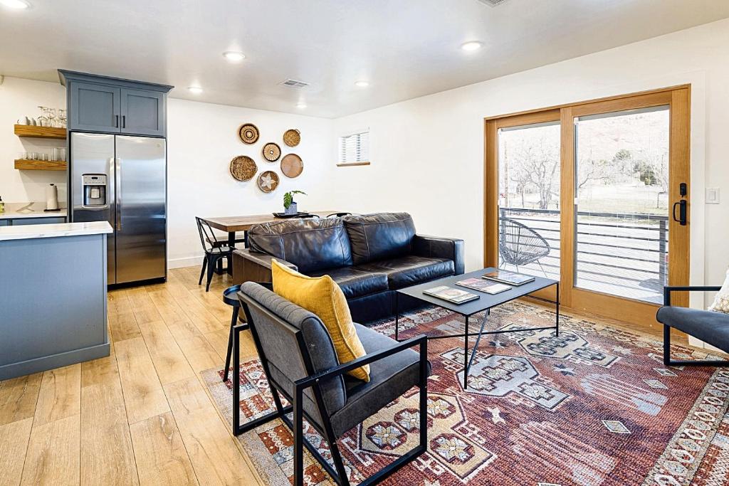 a living room with a couch and a table at Near Downtown Stylish 2BR With Amazing Patio - 4 in Moab