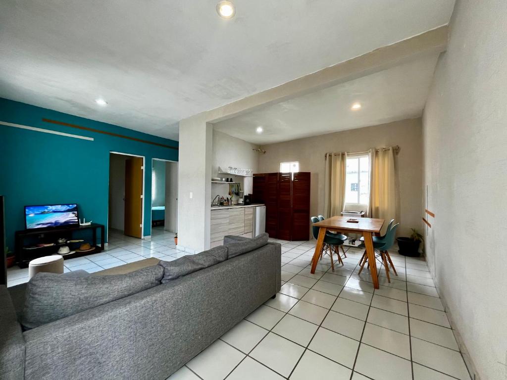 a living room with a couch and a table at Maaya in Puerto Morelos