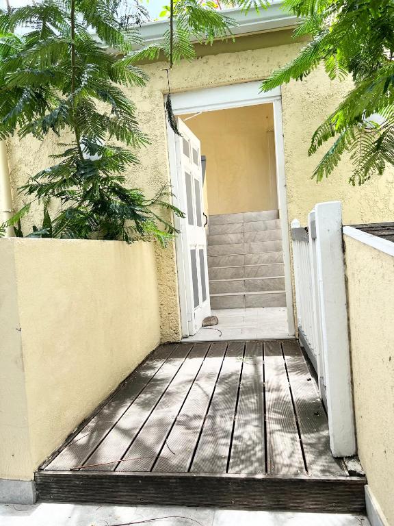 an open door to a house with a porch at Studio Cosi Sxm in Marigot