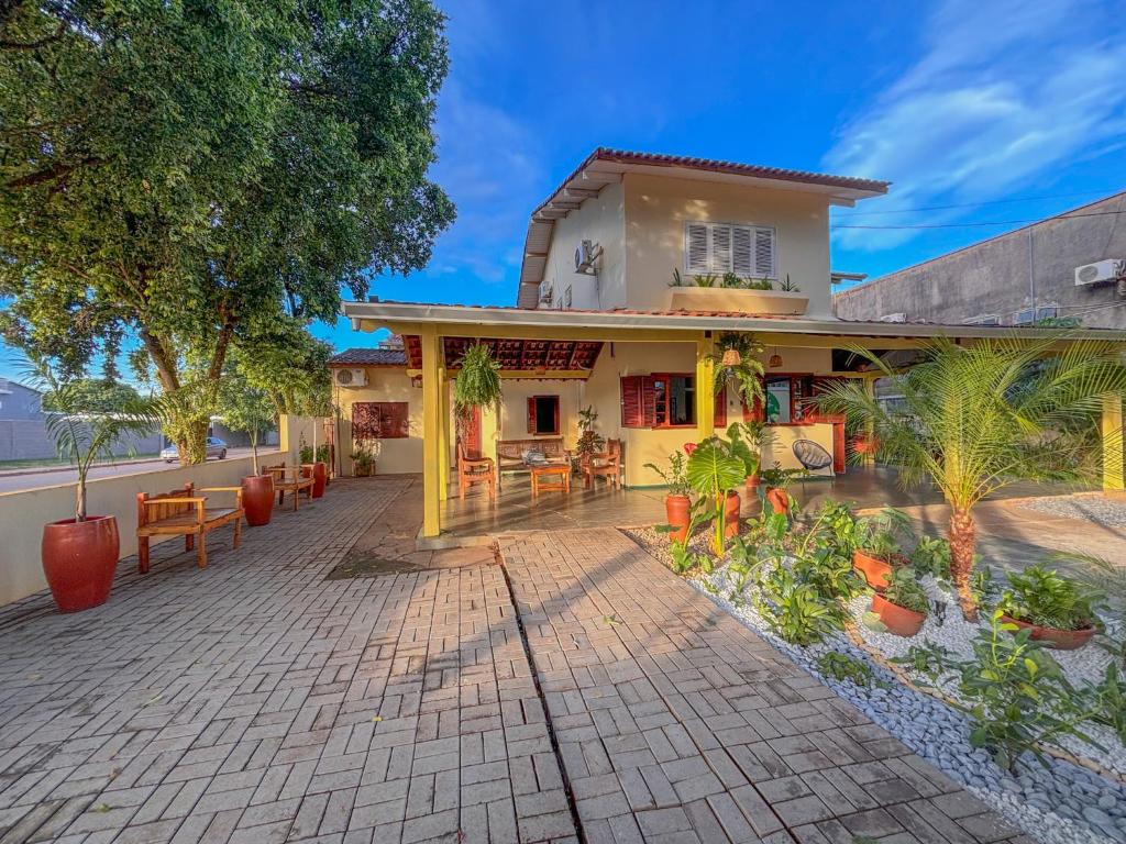 a house with a patio in front of it at Pousada de Bonito in Bonito