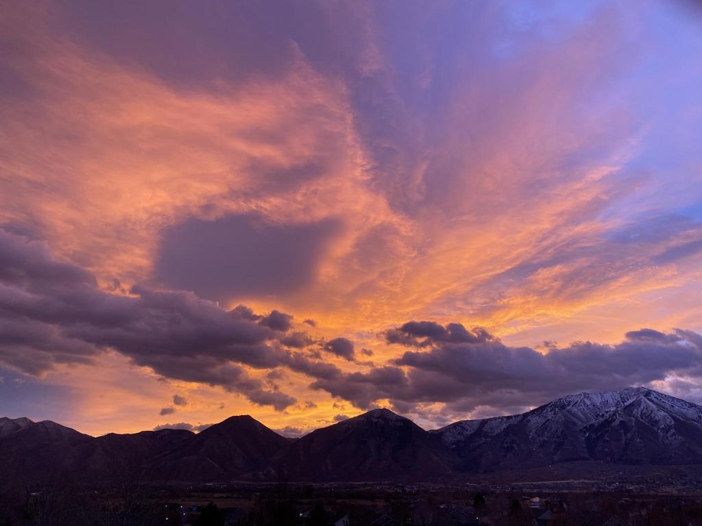 a cloudy sky with mountains in the background at Sleeps 20! Rare Family Friendly House. in Payson