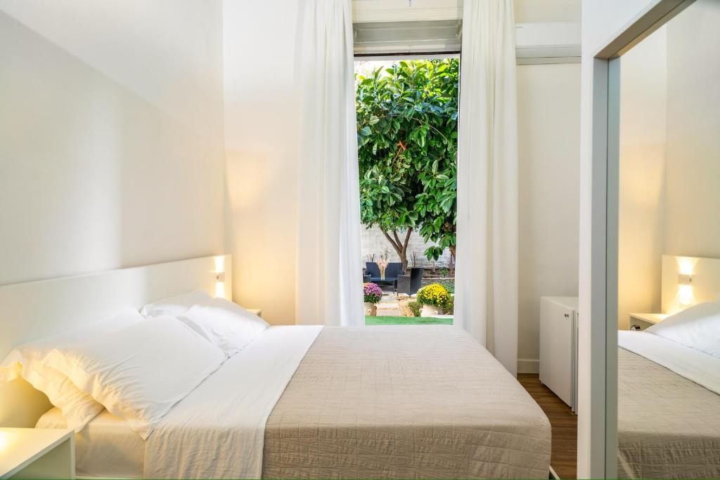 Ένα ή περισσότερα κρεβάτια σε δωμάτιο στο B&B Giardino della Giganza