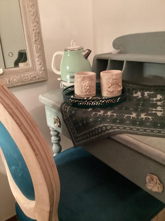 a table with two tea cups on top of it at Bretone XI b&b in Rome