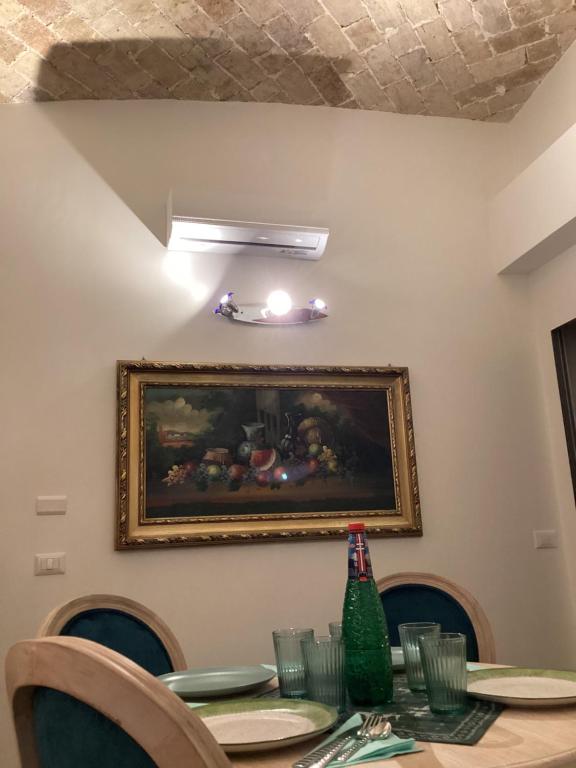 a dining room table with a painting on the wall at Bretone XI b&b in Rome
