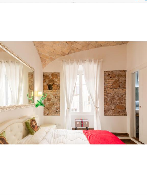 a bedroom with a large bed and a tub at Bretone XI b&b in Rome
