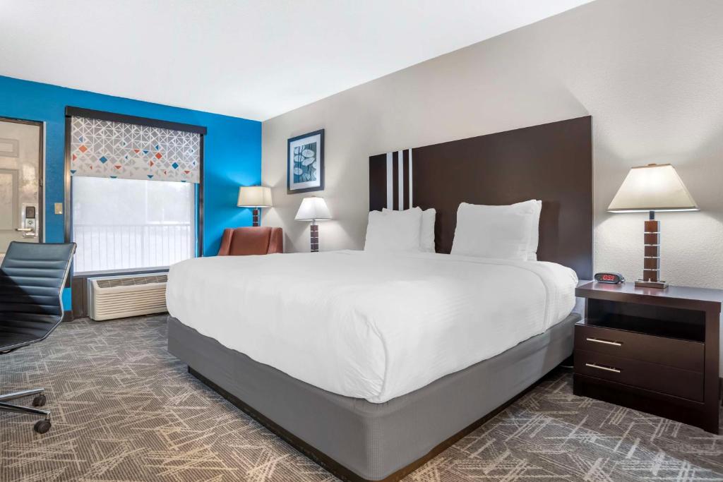 a hotel room with a large bed and a desk at Best Western Andalusia Inn in Andalusia