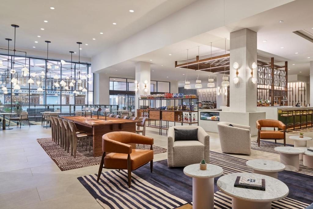 a lobby with a table and chairs at Sheraton Denver Downtown Hotel in Denver