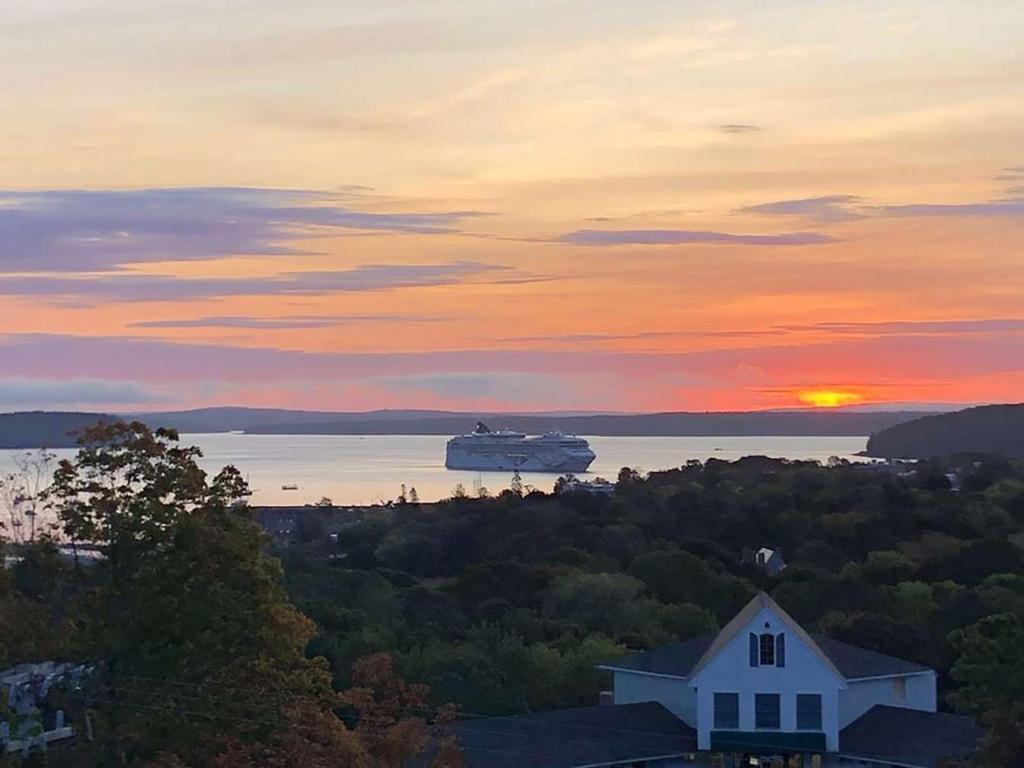 a cruise ship in the water at sunset at Wonder View Inn in Bar Harbor