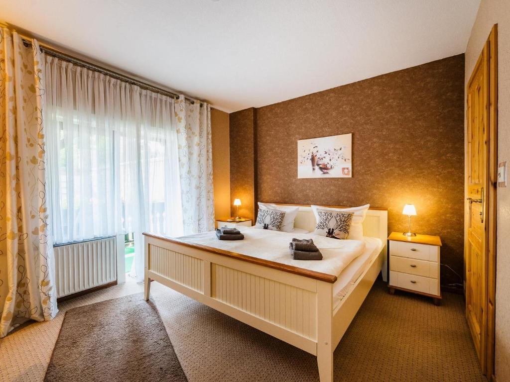 a bedroom with a large bed and a window at Zimmer Nr 4 im Haus Sabine in Braunlage