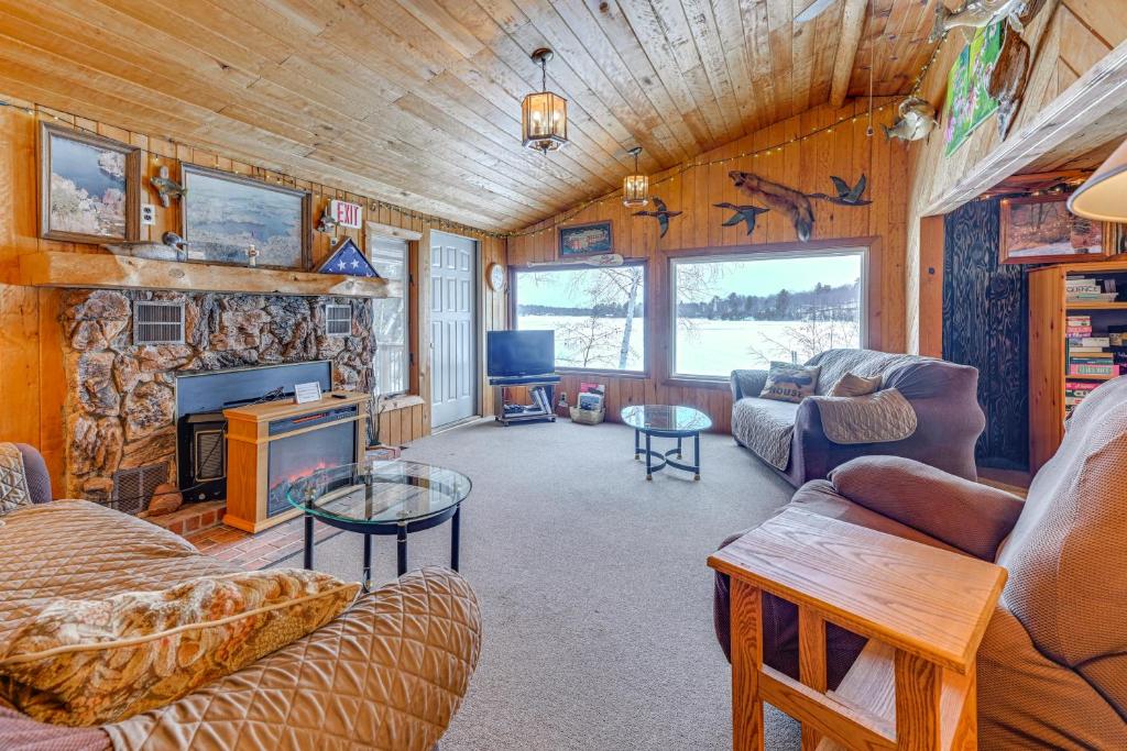 a living room with a couch and a fireplace at Lakefront Suring Home with Pool Table and Views! in Mountain