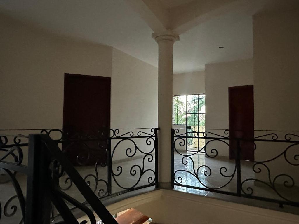 a balcony with a wrought iron railing and a window at Departamento acogedor in Cunduacán