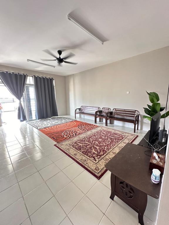 a living room with a bed and a rug at D’ QR Homestay Kuantan in Kuantan