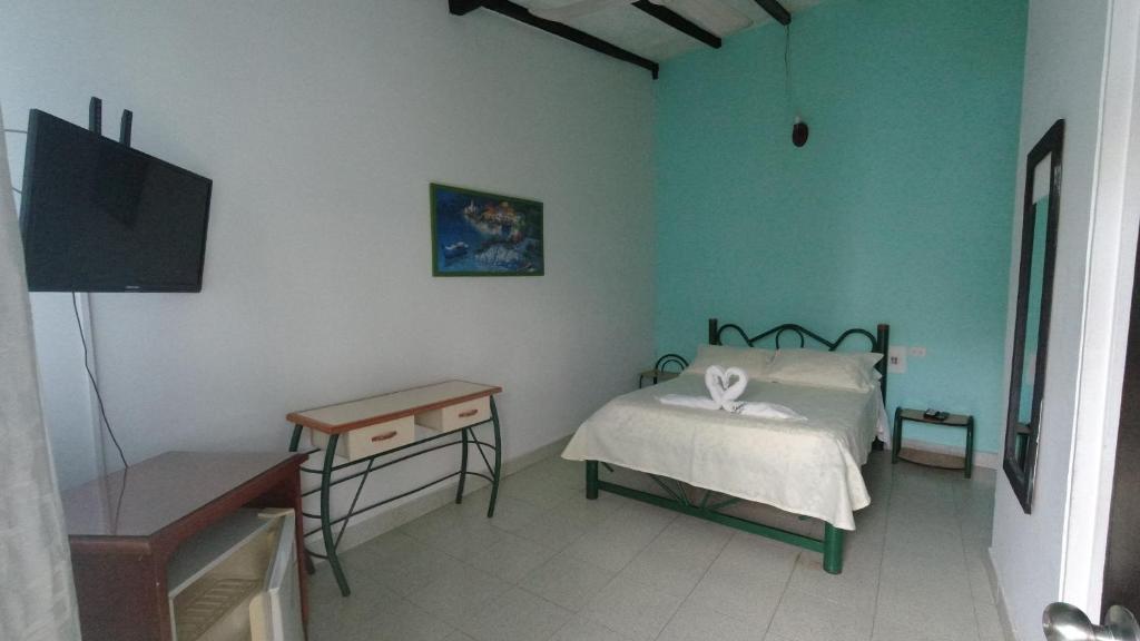 Postel nebo postele na pokoji v ubytování Hotel Miami en Melgar