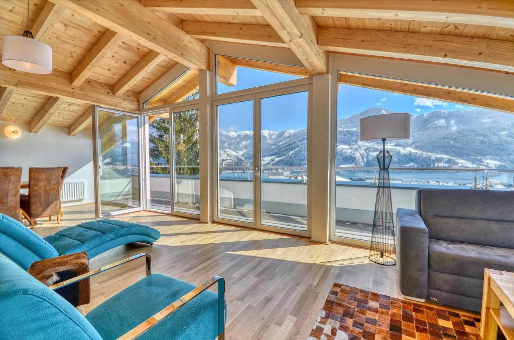 a living room with a view of the mountains at Apartment Snowmountain - by Alpen Apartments in Zell am See