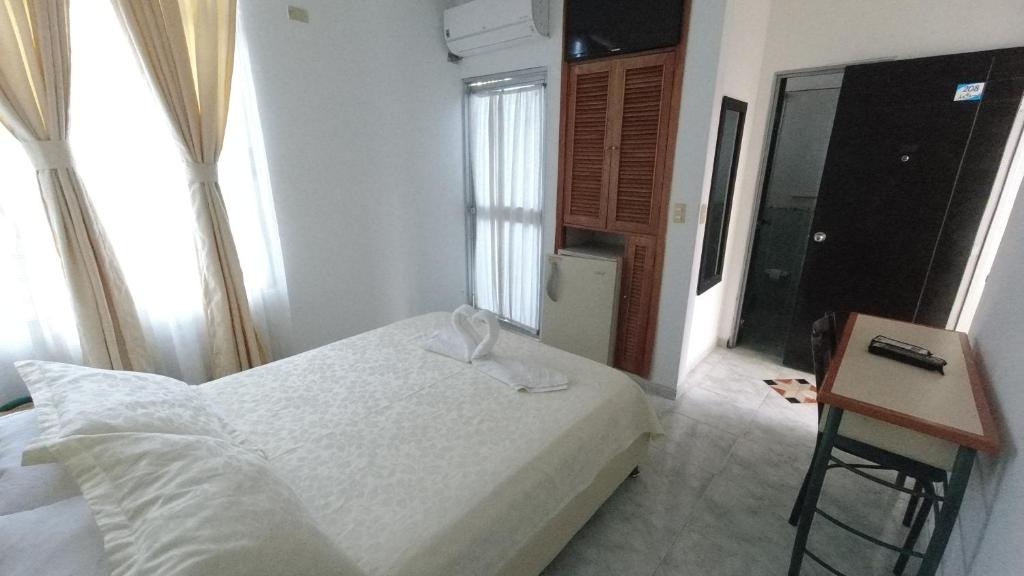 Postel nebo postele na pokoji v ubytování Hotel Miami en Melgar