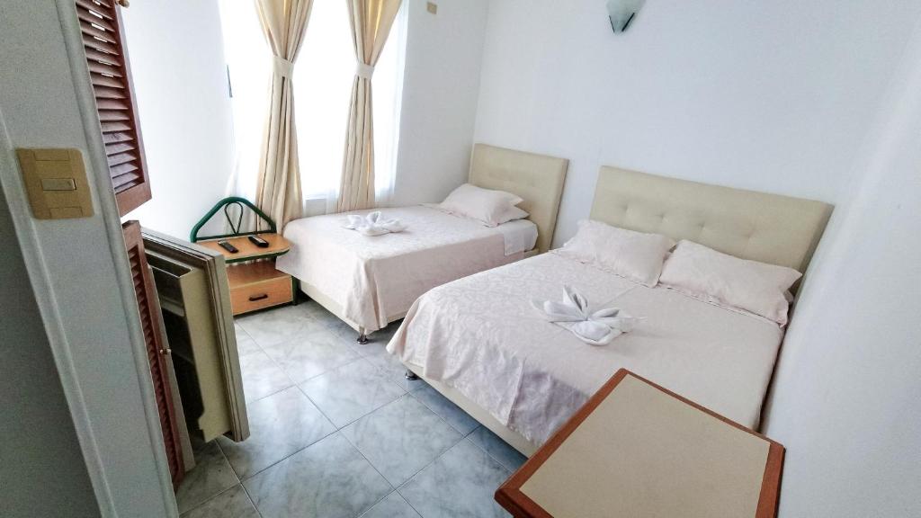 Postel nebo postele na pokoji v ubytování Hotel Miami en Melgar