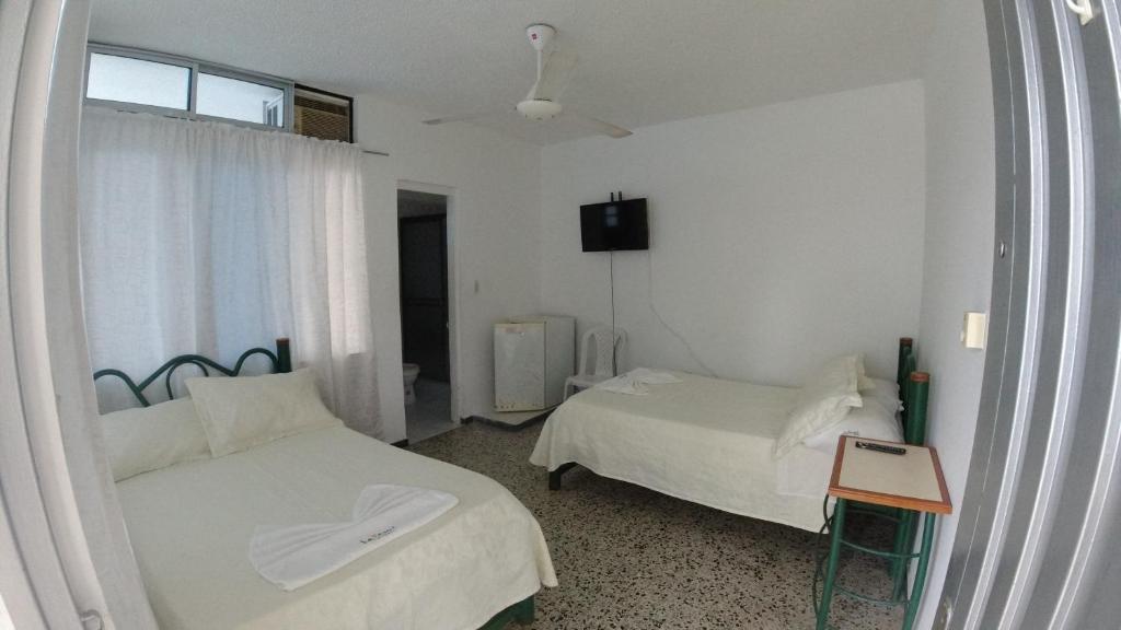 Postel nebo postele na pokoji v ubytování Hotel Miami en Melgar