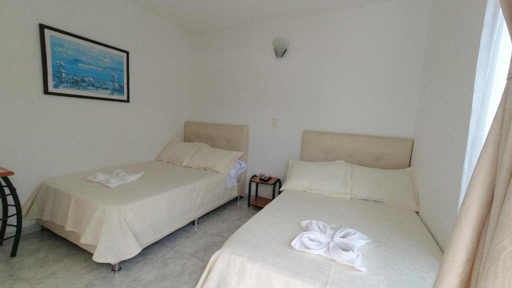 Postel nebo postele na pokoji v ubytování Hotel Miami en Melgar