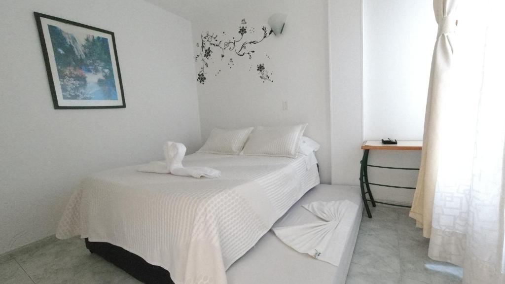 Postel nebo postele na pokoji v ubytování Hotel Miami en Melgar