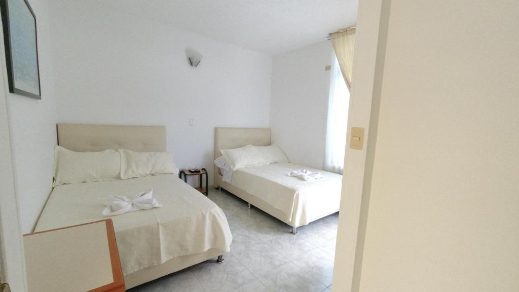 Postel nebo postele na pokoji v ubytování Hotel Miami en Melgar
