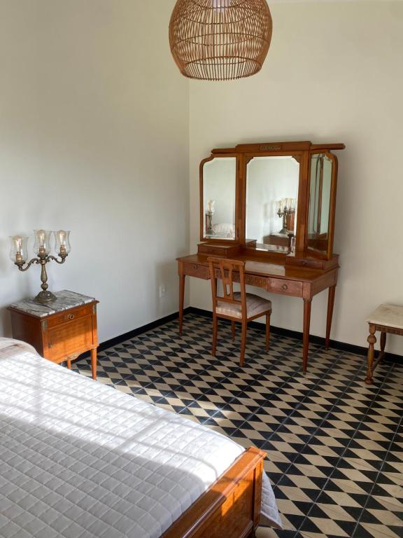 a bedroom with a desk and a mirror and a bed at Doña Hilda in Mercedes