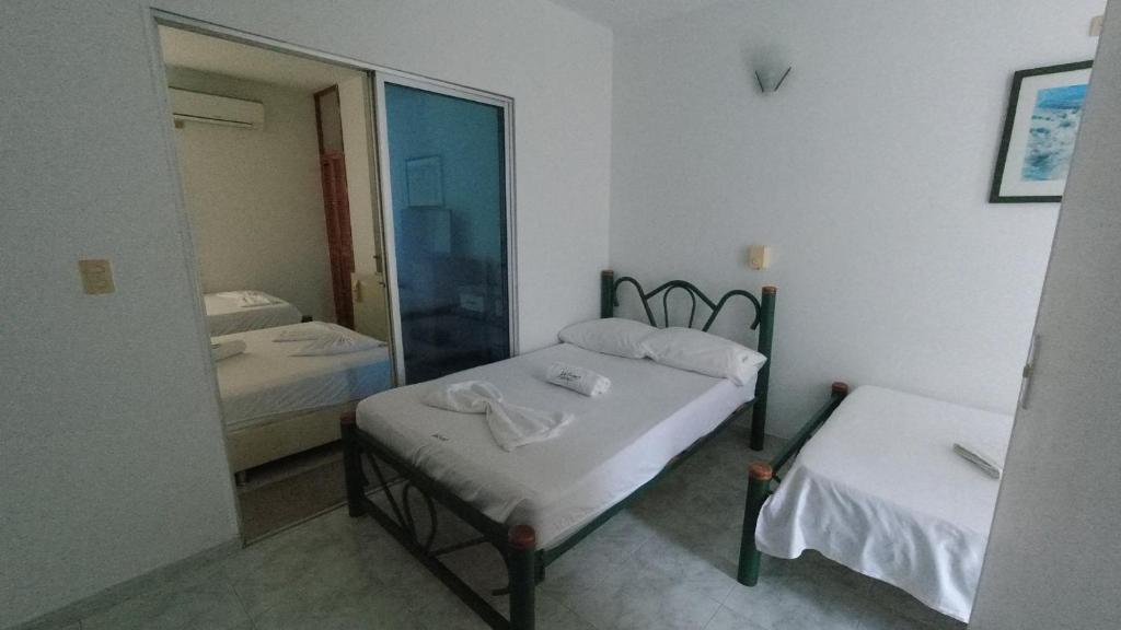 Postel nebo postele na pokoji v ubytování Hotel Miami en Melgar