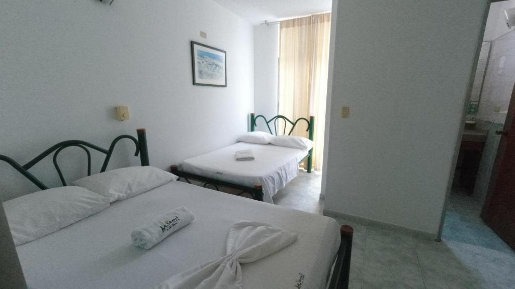 Postel nebo postele na pokoji v ubytování Hotel Miami en Melgar