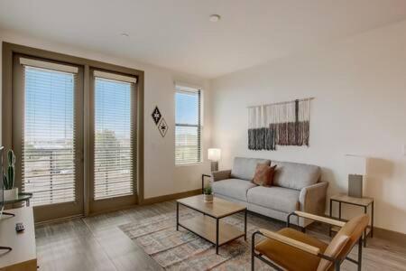 a living room with a couch and a table at Modern 2BR CozySuites on Town Lake waterfront 13 in Tempe
