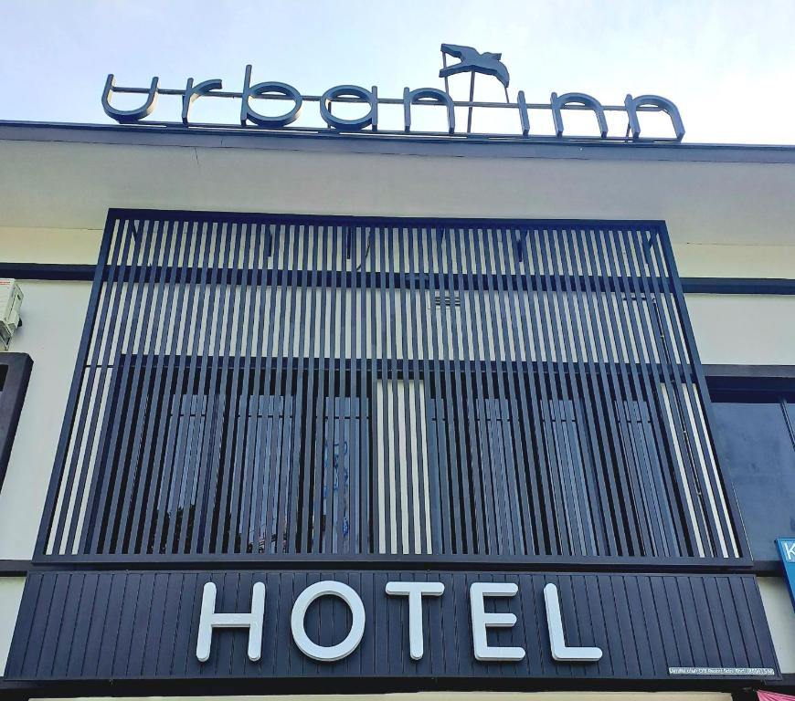 a sign for a hotel on the side of a building at Urban Inn, Salak Tinggi in Sepang