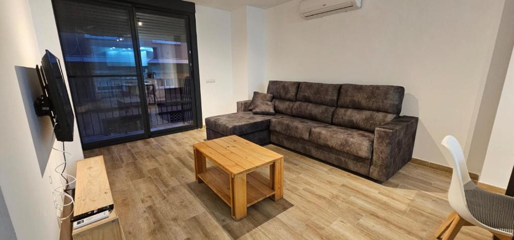 a living room with a couch and a table at Can Pere Antoni Apartamentos in Palma de Mallorca