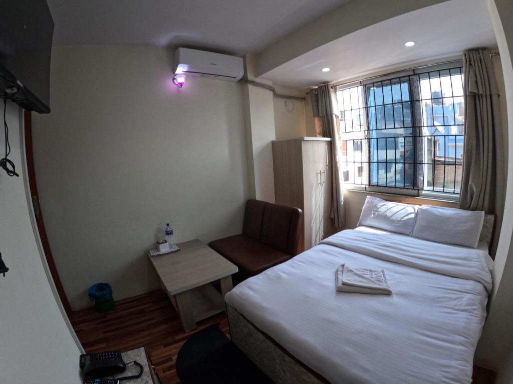 Postel nebo postele na pokoji v ubytování Hotel Global Village